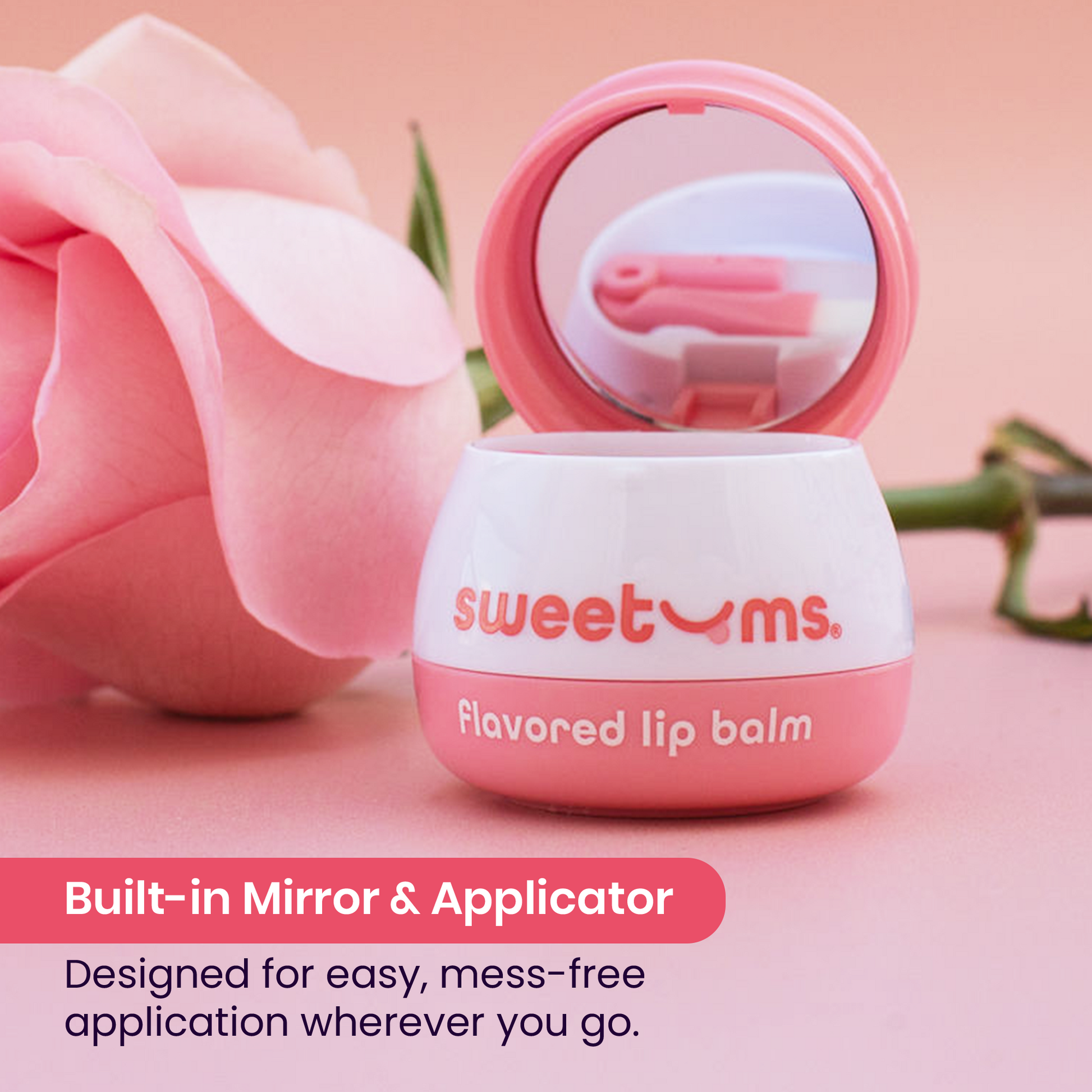 Rose flavored lip balm with mirror and applicator on a pink background with a rose.