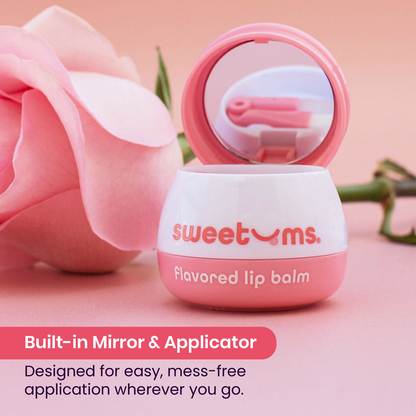 Rose flavored lip balm with mirror and applicator on a pink background with a rose.
