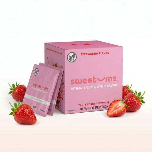Pink packaging of 'sweetums' strawberry-flavored intimate wipes with two packets and strawberries on a white background.