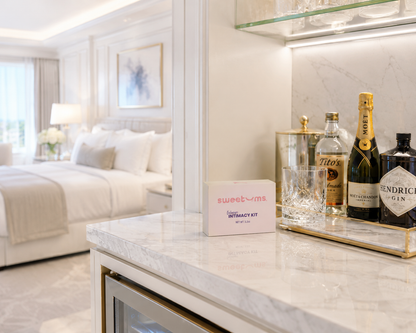 Modern bedroom with marble counter, bottles of alcohol, and a 'sweet vines' product.